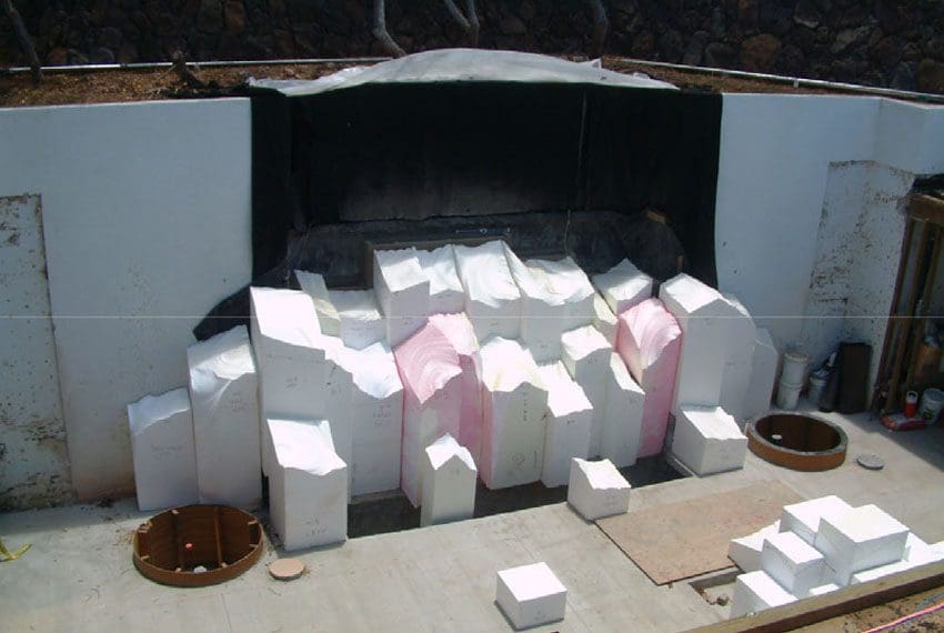 A fireplace with many boxes of white paper